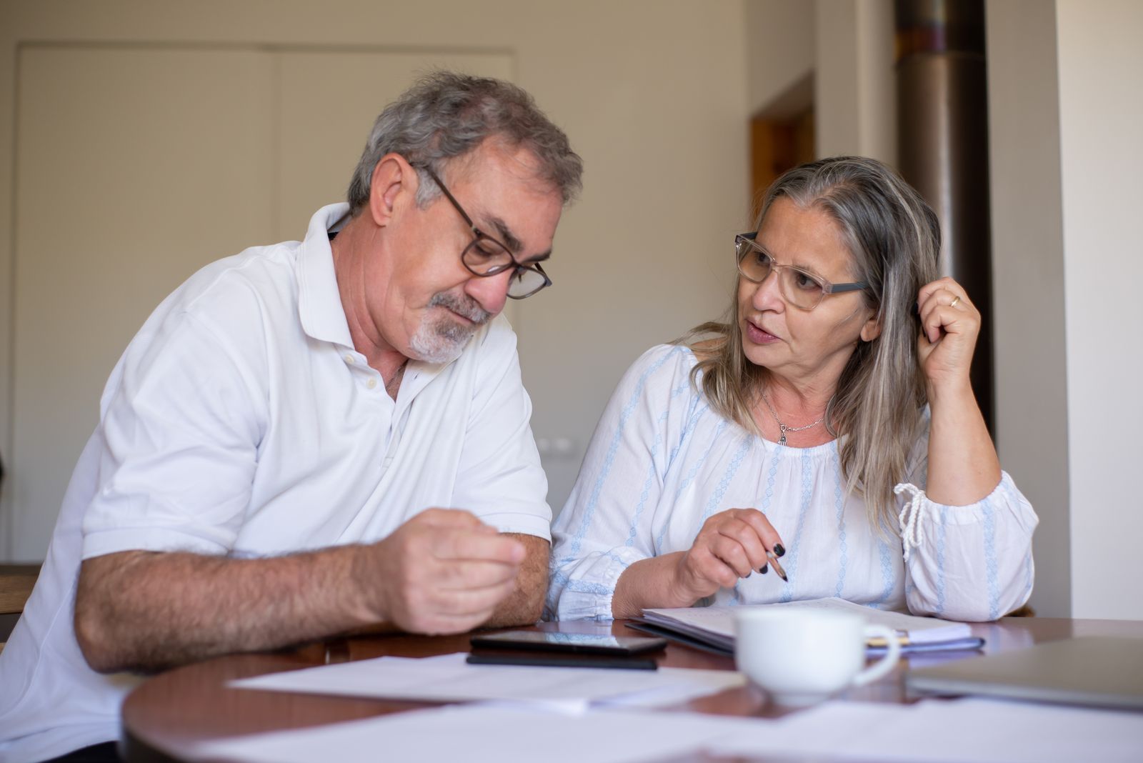 Retired couple reviewing their ongoing financial plan together